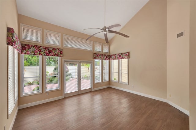 interior space featuring hardwood / wood-style flooring, high vaulted ceiling, and ceiling fan