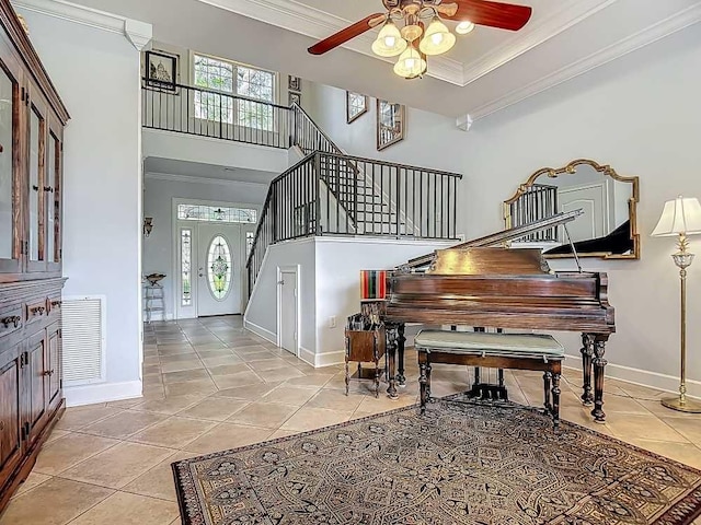 7330 36th Ct, Vero Beach, FL 32967 - foyer featuring ceiling fan, visible vents, crown molding, stairway, and light tile patterned flooring