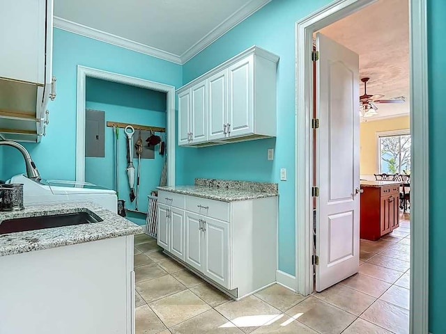 7330 36th Ct, Vero Beach, FL 32967 - washroom featuring cabinet space, a sink, light tile patterned floors, ornamental molding, and electric panel