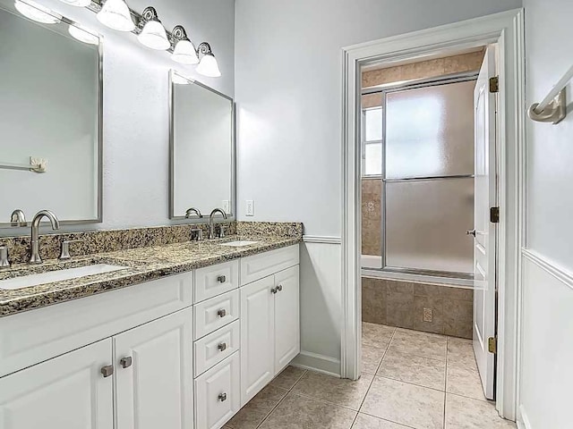 7330 36th Ct, Vero Beach, FL 32967 - bathroom featuring double vanity, baseboards, a sink, and tile patterned flooring