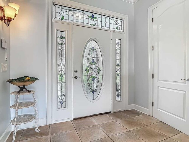 7330 36th Ct, Vero Beach, FL 32967 - entrance foyer featuring baseboards and light tile patterned floors