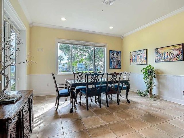 7330 36th Ct, Vero Beach, FL 32967 - dining area with crown molding, wainscoting, light tile patterned flooring, and recessed lighting