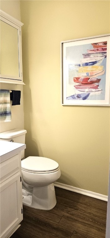 bathroom featuring vanity, toilet, and wood-type flooring