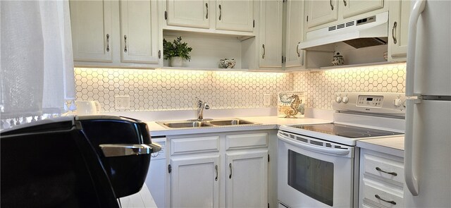 kitchen with white cabinets, white appliances, backsplash, and sink