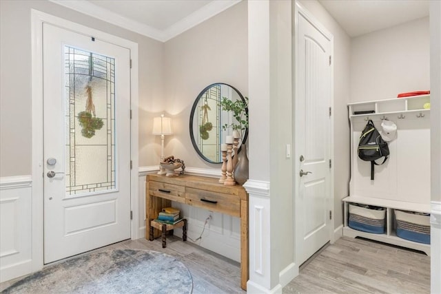 entryway featuring crown molding and light wood-type flooring