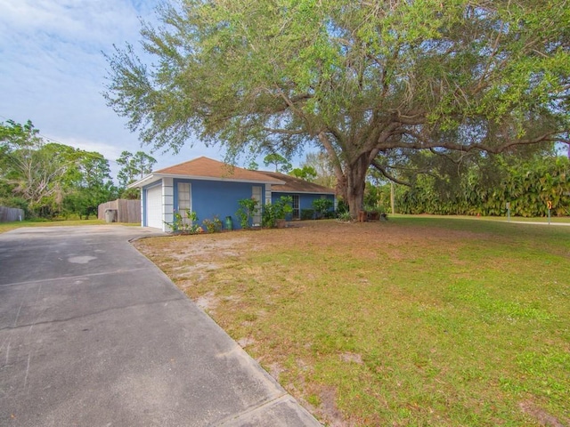 view of front of home with a front lawn and a garage