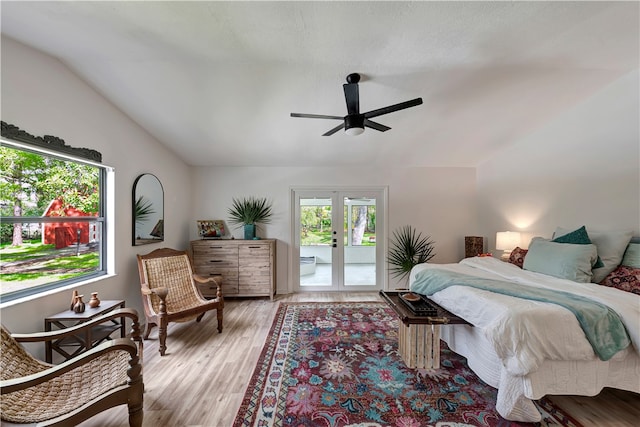 bedroom with ceiling fan, vaulted ceiling, access to outside, light wood-type flooring, and french doors