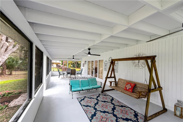 sunroom featuring ceiling fan and beamed ceiling