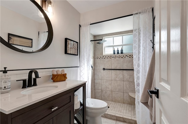 bathroom with toilet, vanity, tile patterned flooring, and a shower with shower curtain