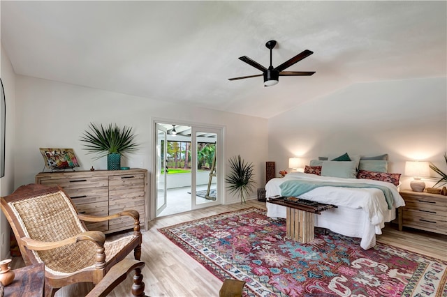 bedroom featuring ceiling fan, access to exterior, lofted ceiling, and hardwood / wood-style flooring