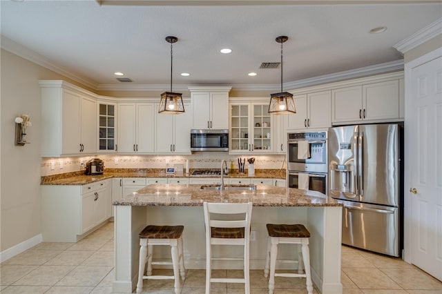 kitchen featuring a kitchen island with sink, ornamental molding, sink, and appliances with stainless steel finishes