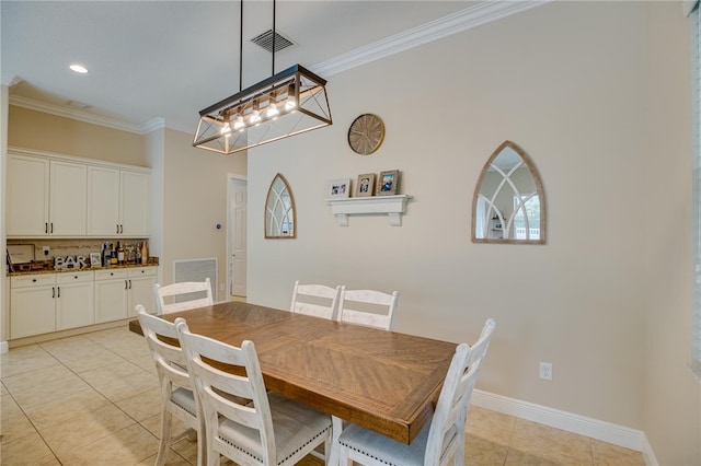 dining room featuring light tile patterned floors and ornamental molding