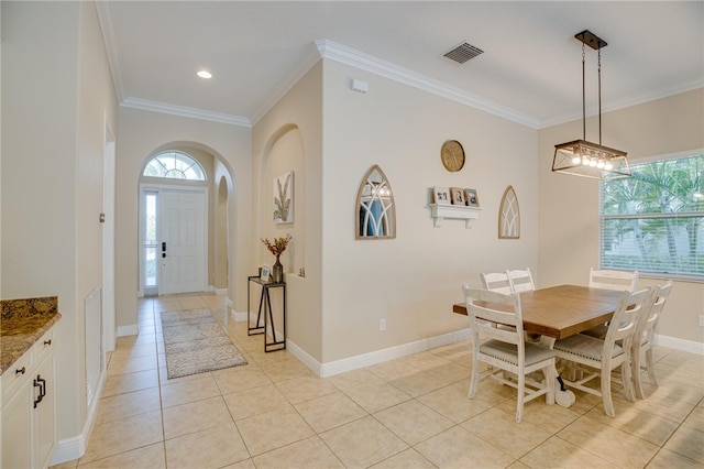 dining room featuring light tile patterned floors and ornamental molding