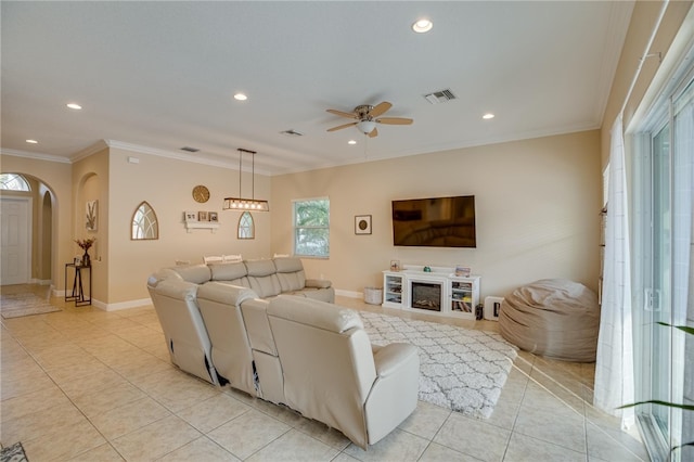 tiled living room featuring ceiling fan and ornamental molding