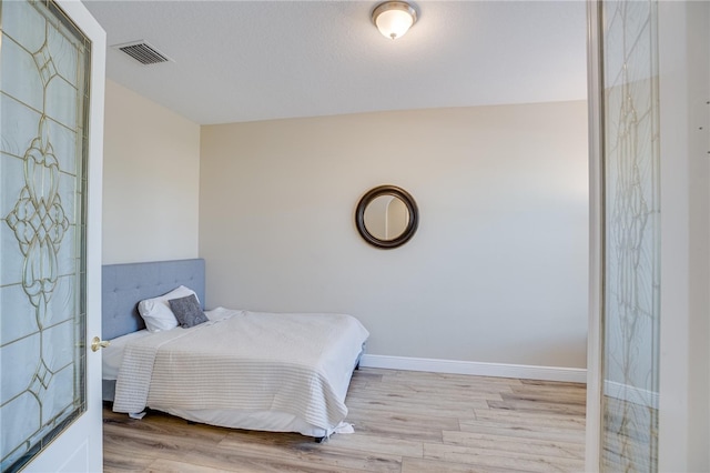 bedroom with light wood-type flooring