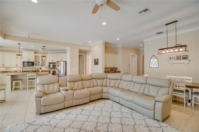 tiled living room featuring ceiling fan, sink, and crown molding