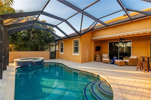 view of swimming pool featuring glass enclosure, ceiling fan, a patio, and an in ground hot tub