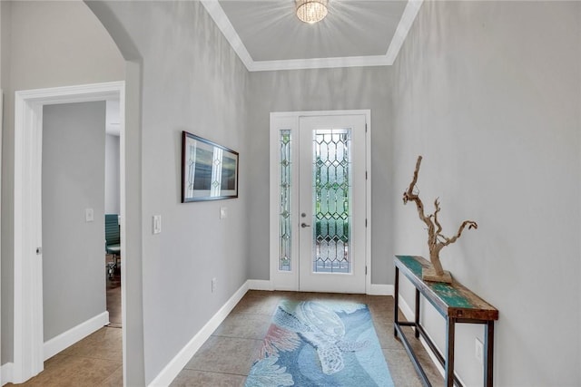 foyer entrance featuring ornamental molding and light tile patterned floors