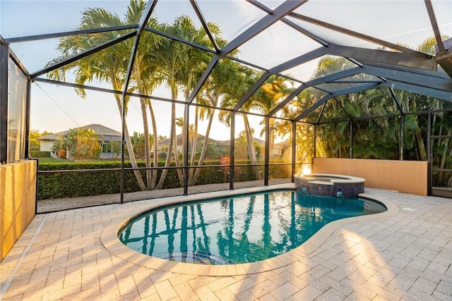 view of swimming pool with an in ground hot tub, a lanai, and a patio area