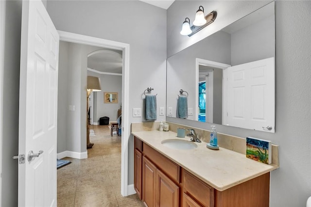 bathroom with tile patterned flooring, vanity, and crown molding