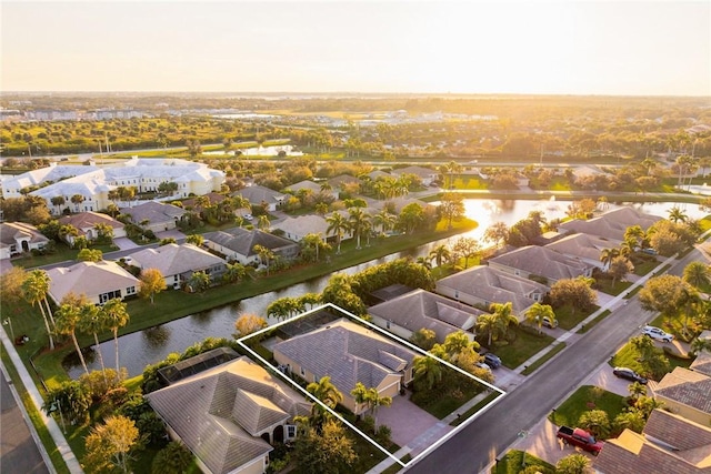 aerial view at dusk with a water view