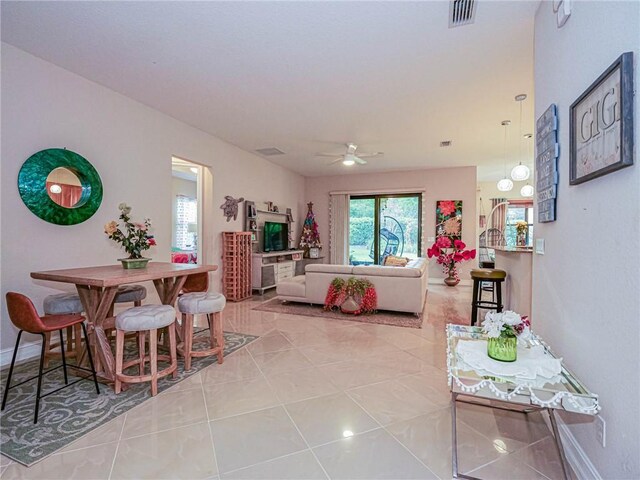 living room with ceiling fan and light tile patterned floors