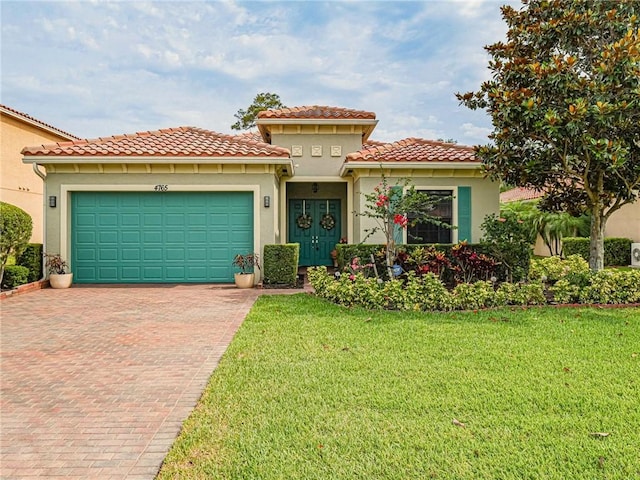 mediterranean / spanish house featuring a garage and a front lawn