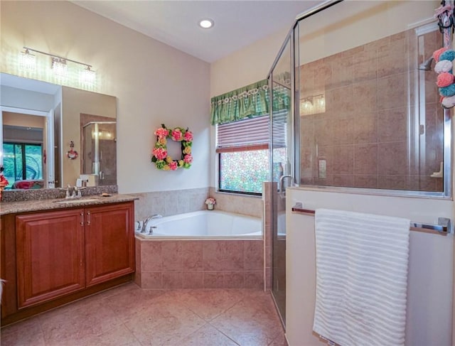 bathroom featuring tile patterned floors, vanity, and shower with separate bathtub