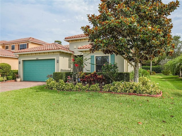 mediterranean / spanish-style house with a front yard and a garage