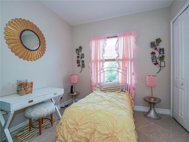 tiled bedroom featuring a closet