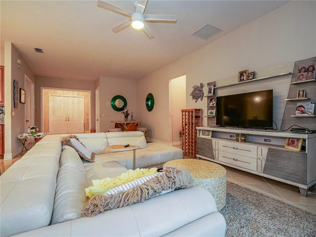 tiled living room with ceiling fan