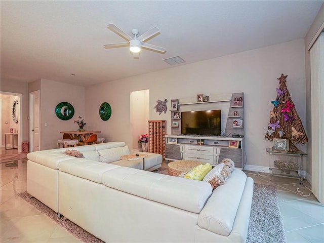 tiled living room featuring ceiling fan