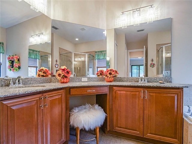 bathroom with tile patterned floors, vanity, and walk in shower