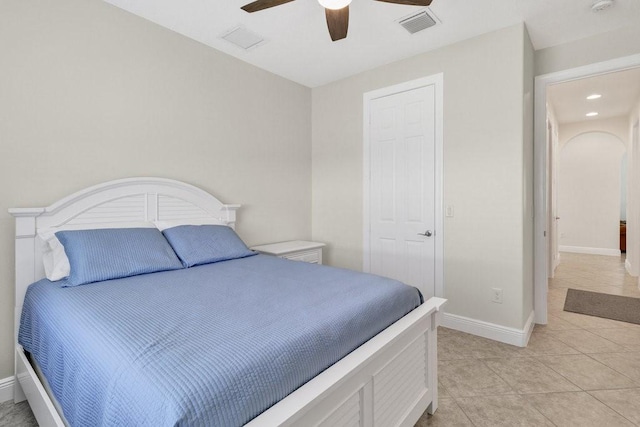 tiled bedroom with ceiling fan