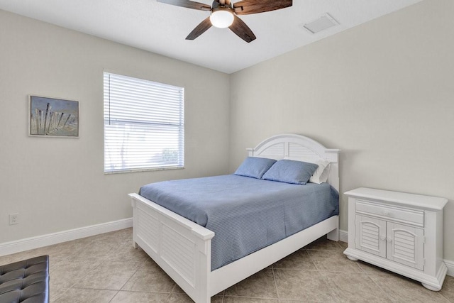 bedroom with ceiling fan and light tile patterned floors