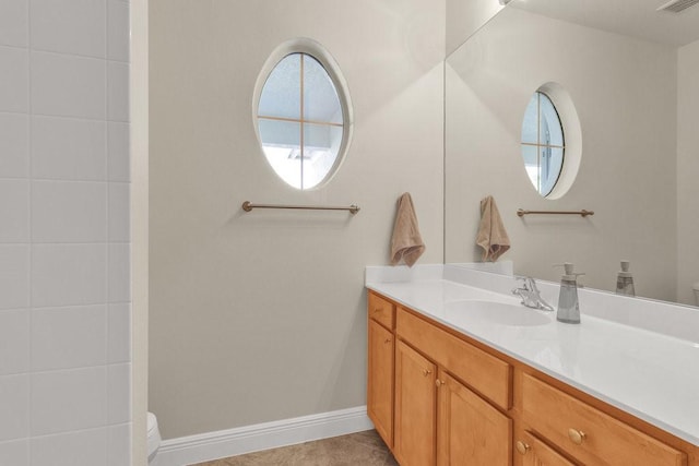 bathroom featuring tile patterned floors, vanity, and toilet