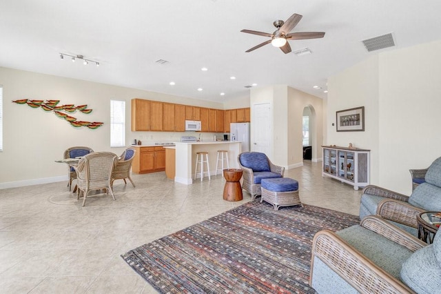 tiled living room featuring ceiling fan