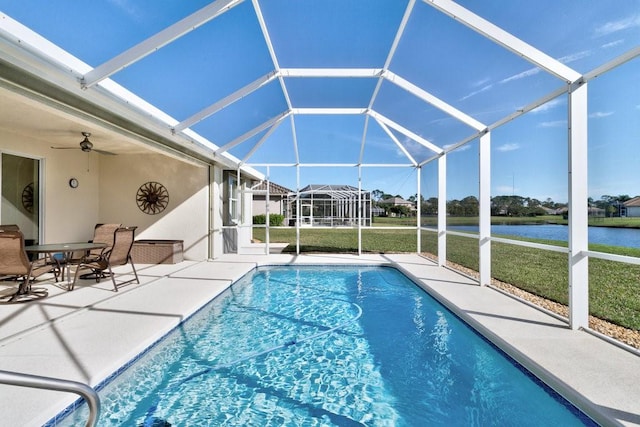 view of swimming pool featuring ceiling fan, a yard, a lanai, a patio area, and a water view