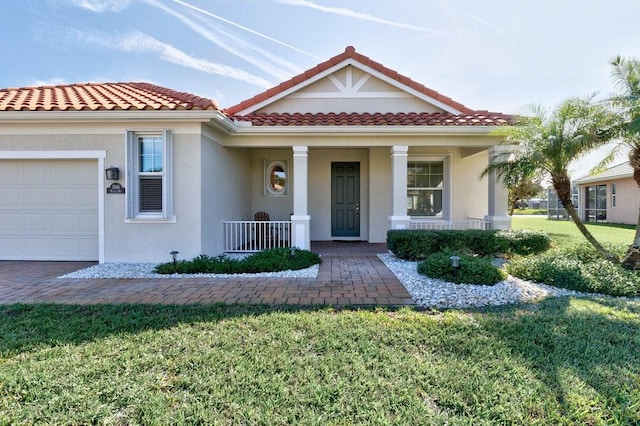 mediterranean / spanish home featuring a front yard, a porch, and a garage