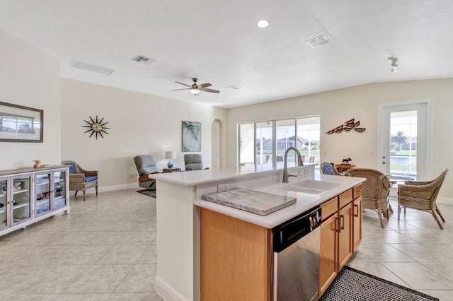 kitchen with ceiling fan, dishwasher, sink, a kitchen island with sink, and light tile patterned floors