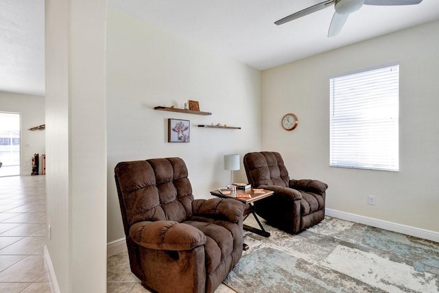 living area featuring ceiling fan, plenty of natural light, and light tile patterned floors