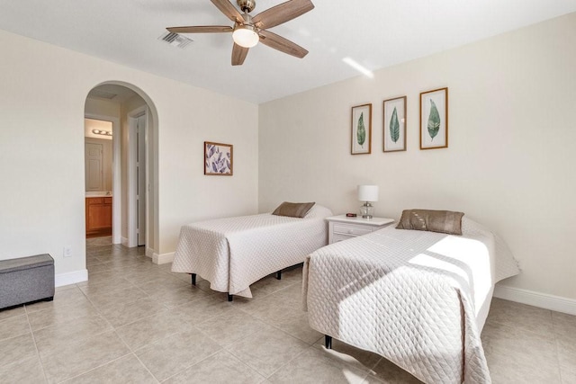 tiled bedroom with connected bathroom and ceiling fan