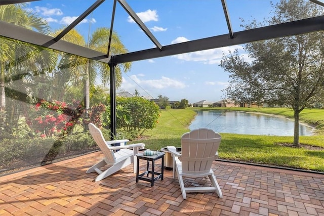 view of patio / terrace featuring a lanai and a water view