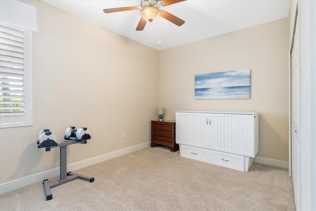 interior space featuring ceiling fan and light carpet