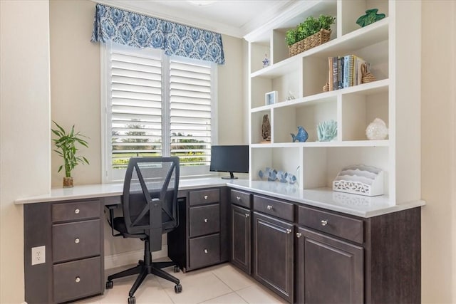 tiled office space with a wealth of natural light, built in desk, and ornamental molding