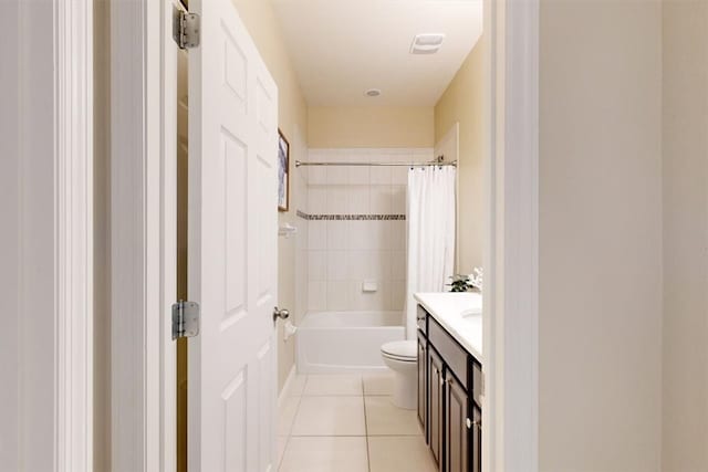 full bathroom with tile patterned floors, vanity, toilet, and shower / bath combo with shower curtain