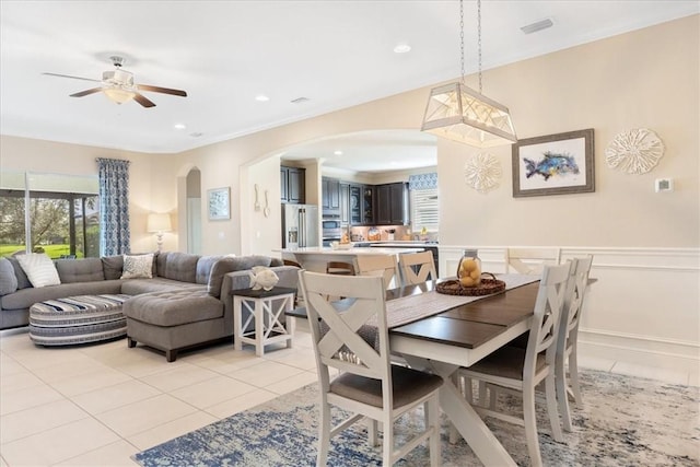 tiled dining area with ceiling fan