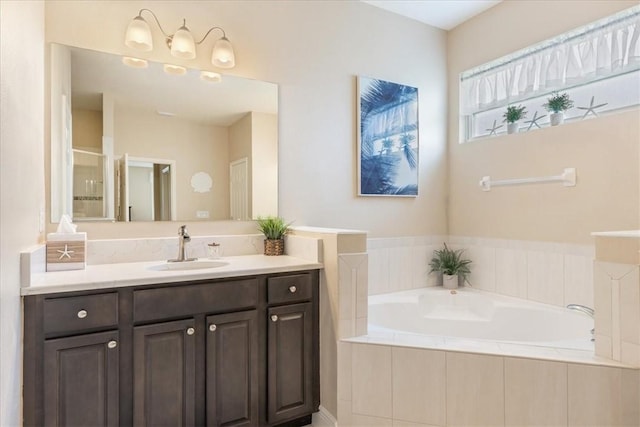 bathroom with vanity and independent shower and bath