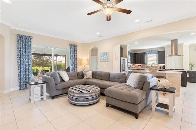 living room featuring sink, ceiling fan, ornamental molding, and light tile patterned flooring