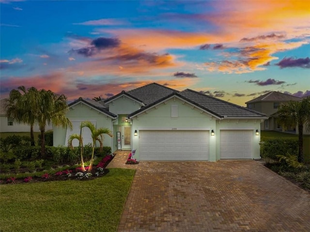 view of front of home featuring a lawn and a garage